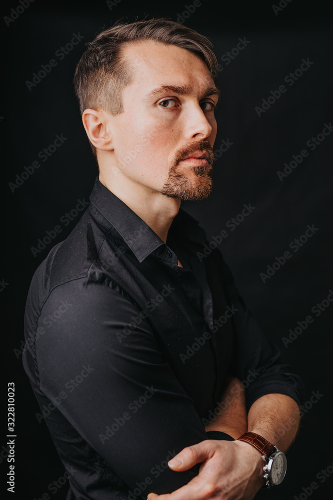 Handsome man. Photo in a photo studio on a black background. A young man expresses his emotions with expressions, gesticulation and attitude. Handsome man. Photo in a photo studio on a black background. A young man expresses his emotions with expressions, gesticulation and attitude.