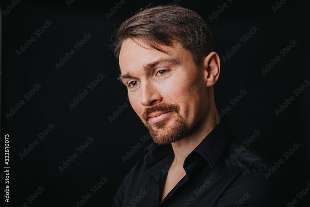 Handsome man. Photo in a photo studio on a black background. A young man expresses his emotions with expressions, gesticulation and attitude. Handsome man. Photo in a photo studio on a black background. A young man expresses his emotions with expressions, gesticulation and attitude.