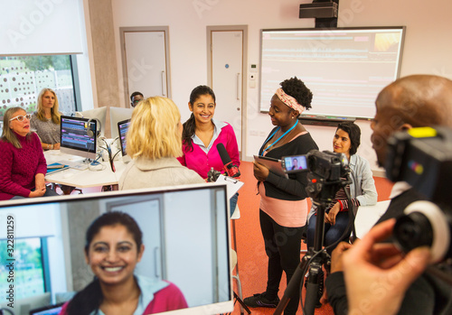 Community college students filming in media classroom photo