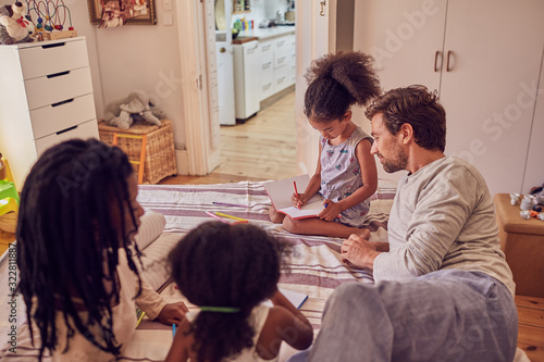 Young family coloring on bed photo