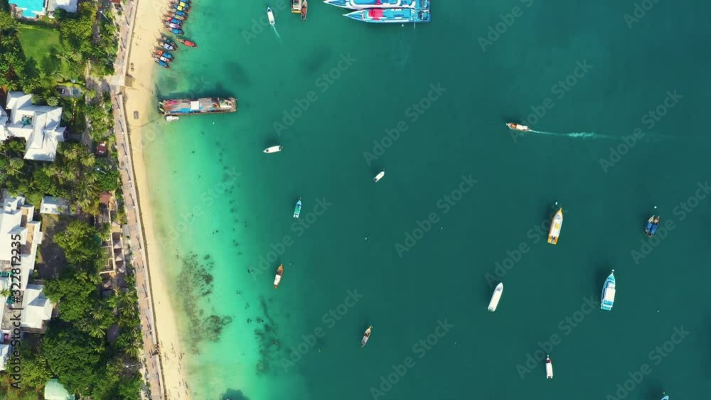 AERIAL Stunning shot of tropical island harbor on a refreshing tranquil morning. Moored boats and ferries wait for crowds of tourists to take them island hopping around the spectacular Phi Phi Islands AERIAL Stunning shot of tropical island harbor on a refreshing tranquil morning. Moored boats and ferries wait for crowds of tourists to take them island hopping around the spectacular Phi Phi Islands
