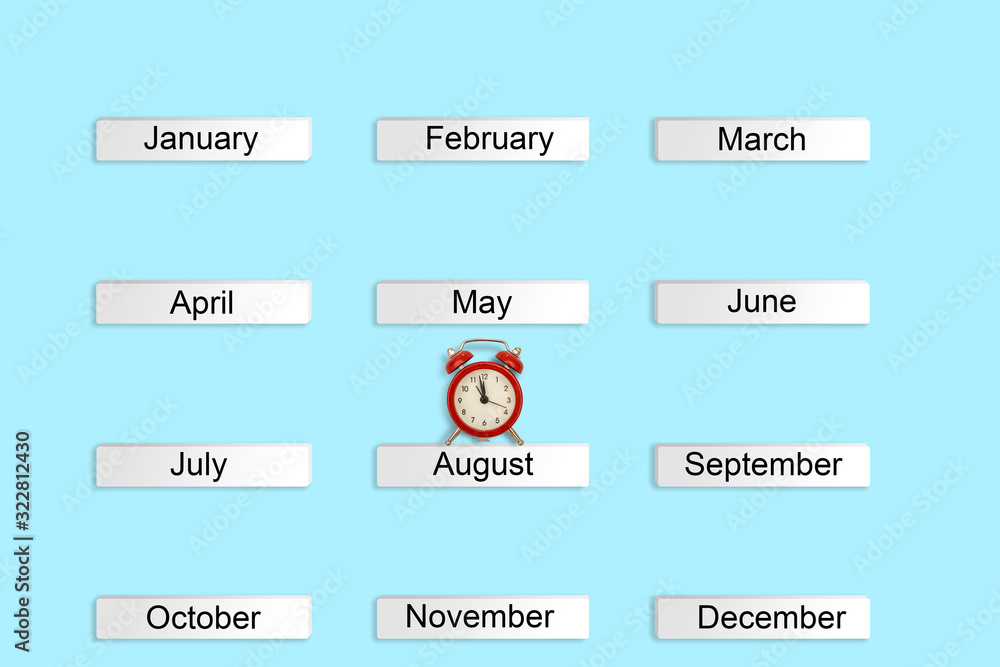 calendar autumn months and red alarm clock on blue background. Concept time Creative Top view Flat Lay Minimal style Copy space calendar autumn months and red alarm clock on blue background. Concept time Creative Top view Flat Lay Minimal style Copy space