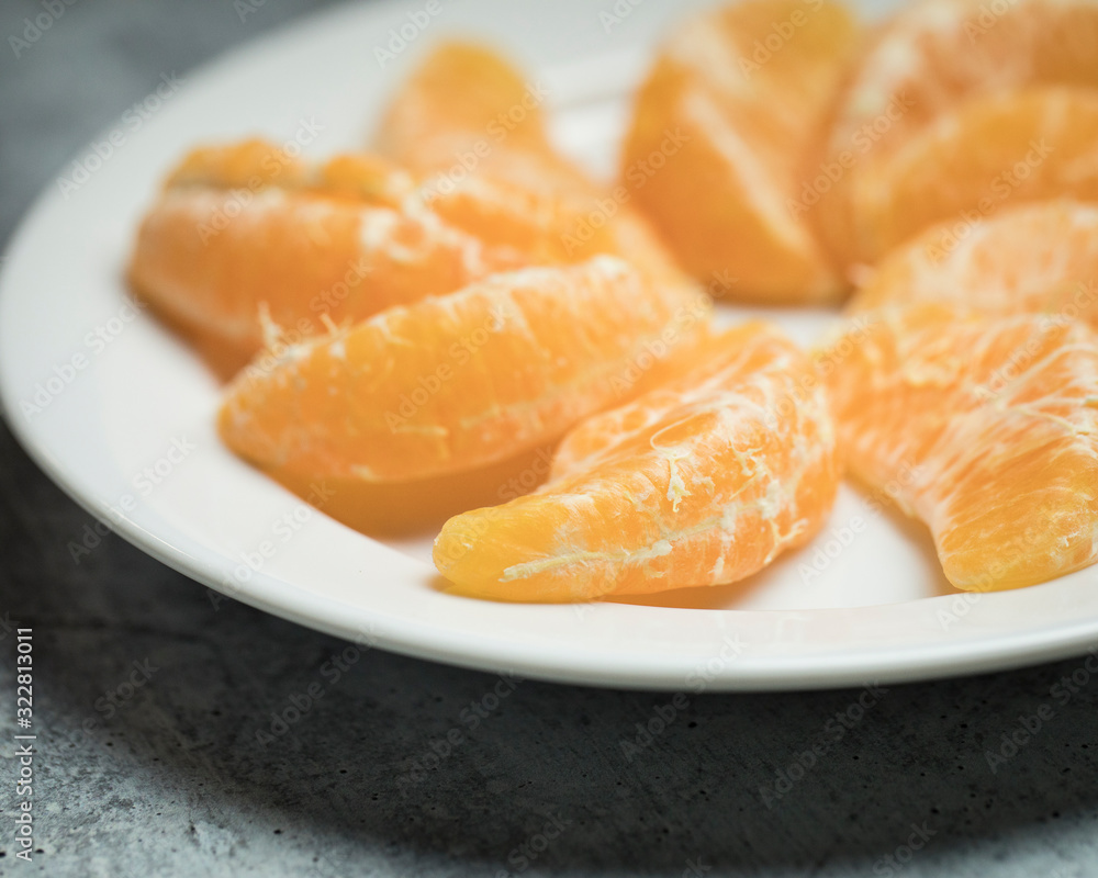 Close up of a Healthy orange snack on a white plate ready for the healthy gluten free diet and weight loss Close up of a Healthy orange snack on a white plate ready for the healthy gluten free diet and weight loss
