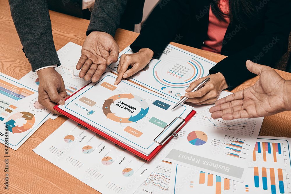 Close up of executive managing director check big project report with secretary Close up of executive managing director check big project report with secretary