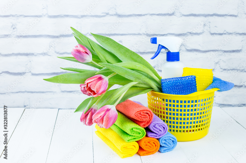 Spring cleaning holiday concept, supplies and tools for cleaning and spring flowers. Liquid disinfectants, sponges and cleaning cloths. Copy space Spring cleaning holiday concept, supplies and tools for cleaning and spring flowers. Liquid disinfectants, sponges and cleaning cloths. Copy space