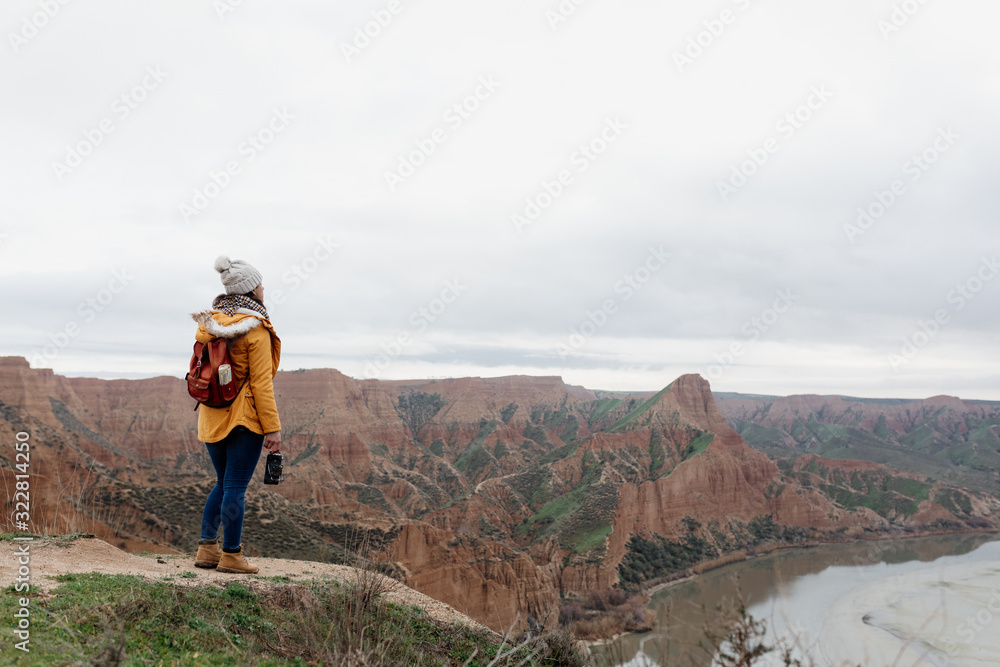 young girl traveling the world with her backpack hiking