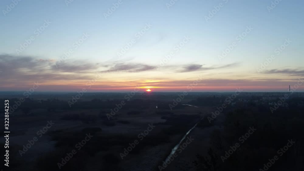 Sunrise on the background of a single crane. Flight under the boom of a crane. Sunrise on the background of a single crane. Flight under the boom of a crane.