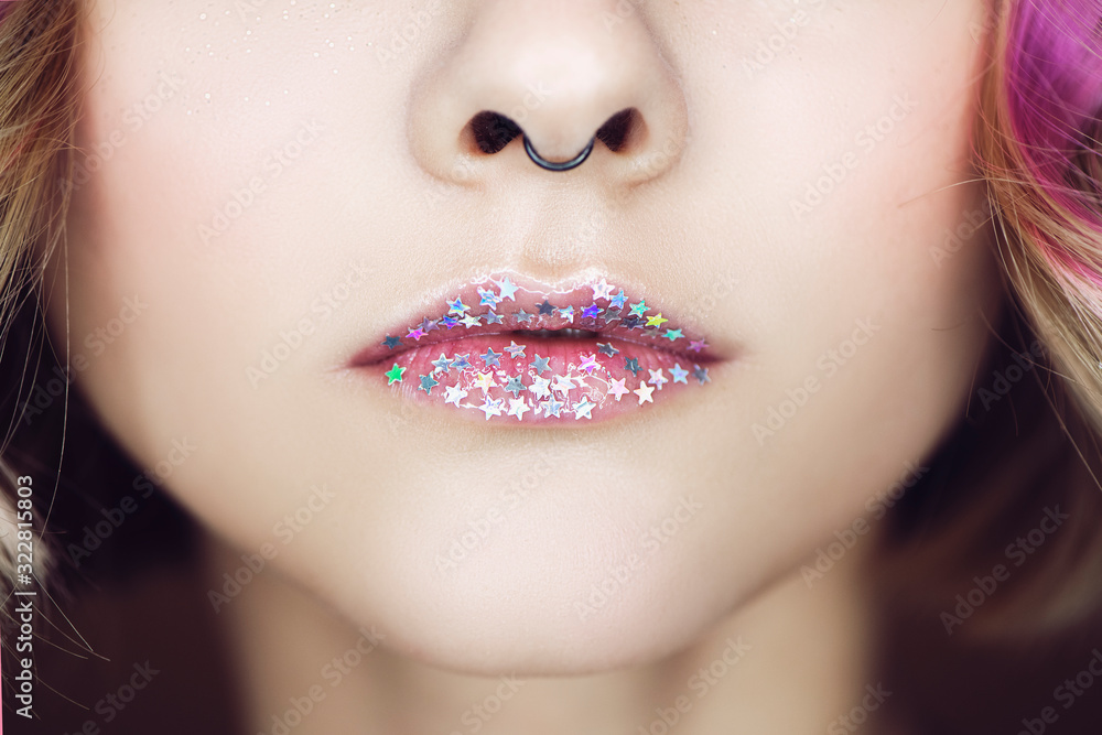 Cropped view of beautiful woman with glitter stars on lips. Cropped view of beautiful woman with glitter stars on lips.