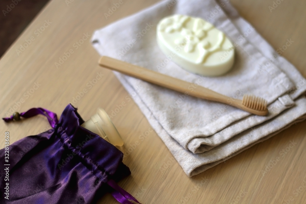 Linen cloth, soap, bamboo toothbrush and menstrual cup. Zero waste bathroom products. Selective focus.