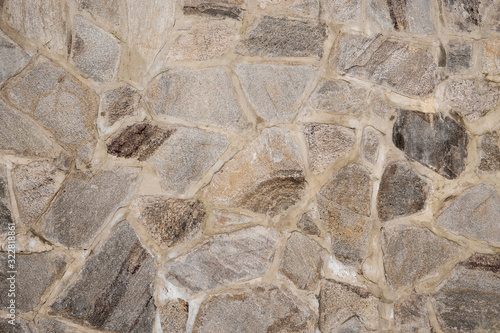 The wall is made of masonry cobblestones.
