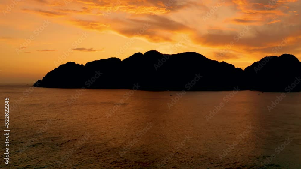Amazing colorful sunset behind an island. Ko Phi Phi Thailand at dusk. Aerial Amazing colorful sunset behind an island. Ko Phi Phi Thailand at dusk. Aerial