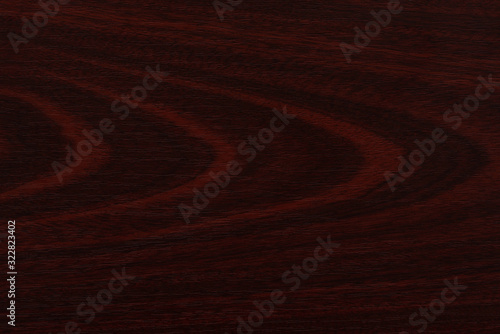 Striped cherry color material as light brown background, close up © NCirmu