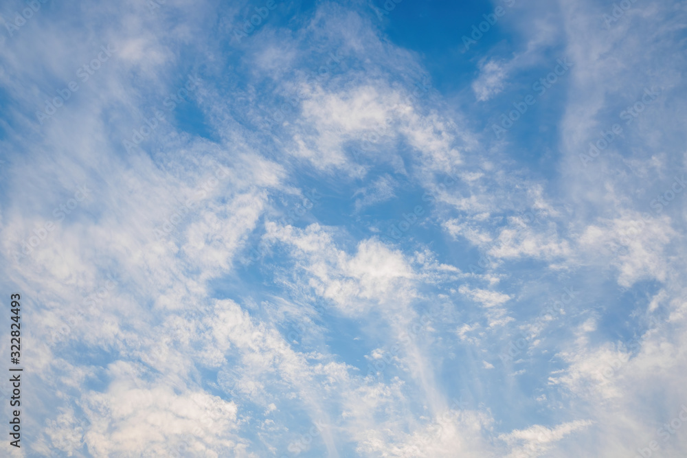 Beautiful blue sky with cirrus clouds. Natural background without focus, empty pattern for copy space