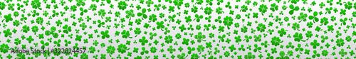Banner on St. Patrick's Day made of clover leaves in green colors with seamless horizontal repetition