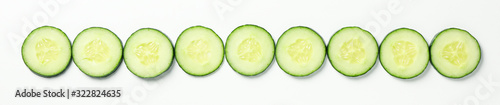 Flat lay with cucumber slices on white background, top view