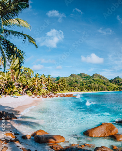 Mahe  Seychelles. Beautiful Anse intendance beach. Calm ocean waves rolling towards the shore with coconut palm trees
