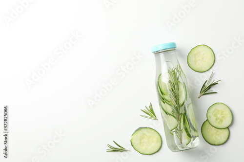 Tableau sur toile Bottle with infused cucumber water on white background, space for text