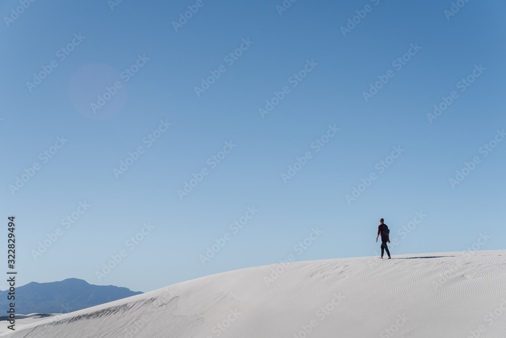 A man walking in the distance at White Sands National Park in Alamogordo, New Mexico. 