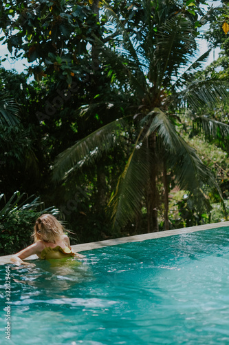 Young woman in infinity pool in the jungle in Ubud, Bali © Jekaterina Berkovich