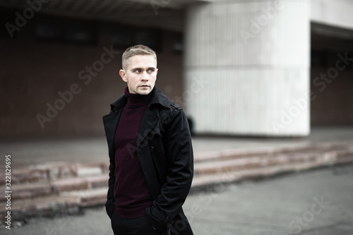 Fotografia Serious man in black trenchcoat