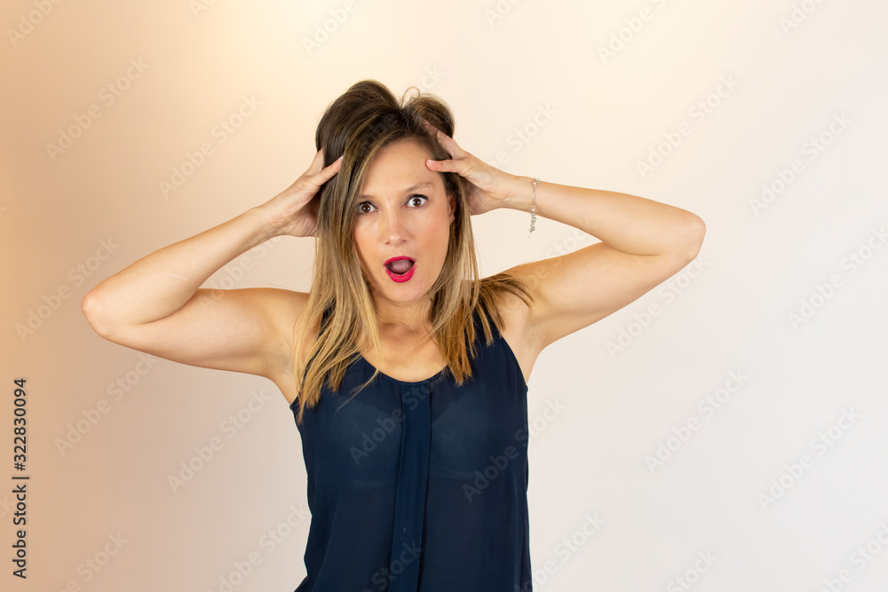 Young adult with her hands on her head surprised Young adult with her hands on her head surprised