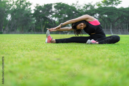 Women perform exercises by focusing on the torso and back muscles before exercising in the park.