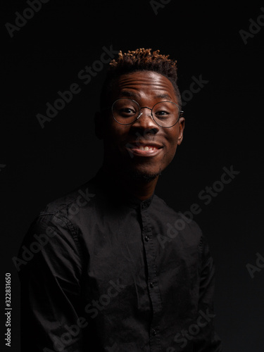 Portrait of an African man on a dark background. Studio shooting.