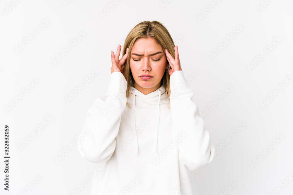 Young blonde caucasian woman isolated touching temples and having headache. Young blonde caucasian woman isolated touching temples and having headache.