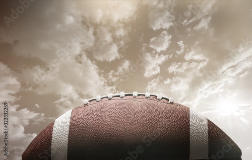 American football ball on sky background