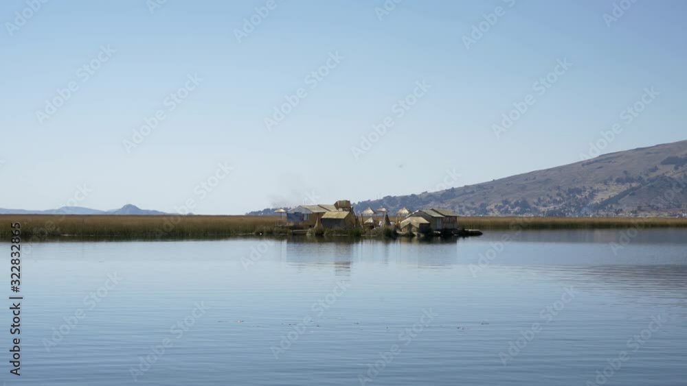 Traditional Uros floating reed islands on Lake Titicaca in the Andes Mountains at the border between Peru and Bolivia Traditional Uros floating reed islands on Lake Titicaca in the Andes Mountains at the border between Peru and Bolivia