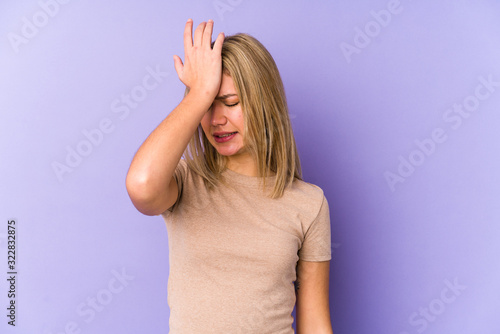 Young blonde caucasian woman isolated forgetting something, slapping forehead with palm and closing eyes.