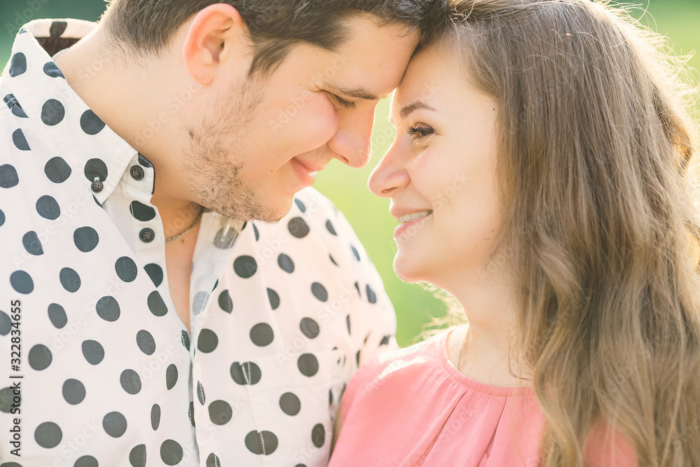 happy expectant parents lean their heads together and smile. clo happy expectant parents lean their heads together and smile. clo