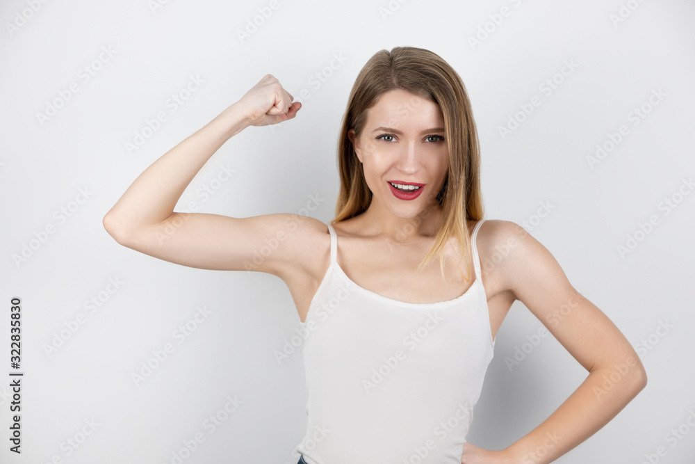 beautiful fit blond woman demonstrates her arm biceps standing on isolated white background, healthcare and sport concept beautiful fit blond woman demonstrates her arm biceps standing on isolated white background, healthcare and sport concept