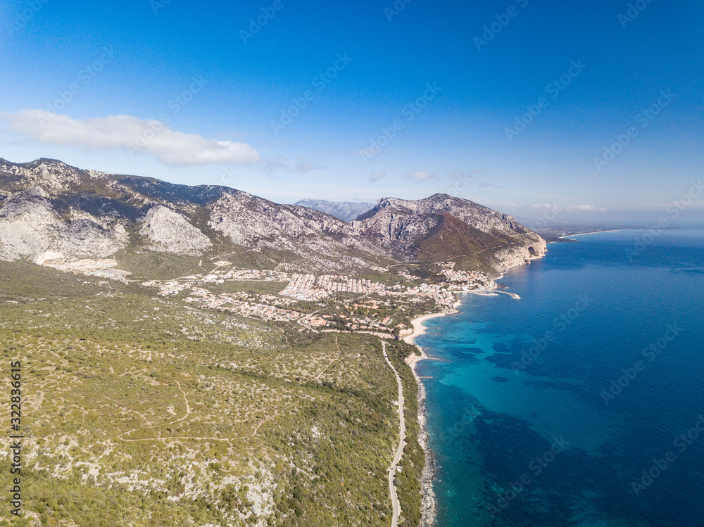 AERIAL VIEW OF THE CALA GONONE COAST,BEAUTIFUL LANDSCAPE WITH THE ROCKY MOUNTAINS IN BACKGROUND