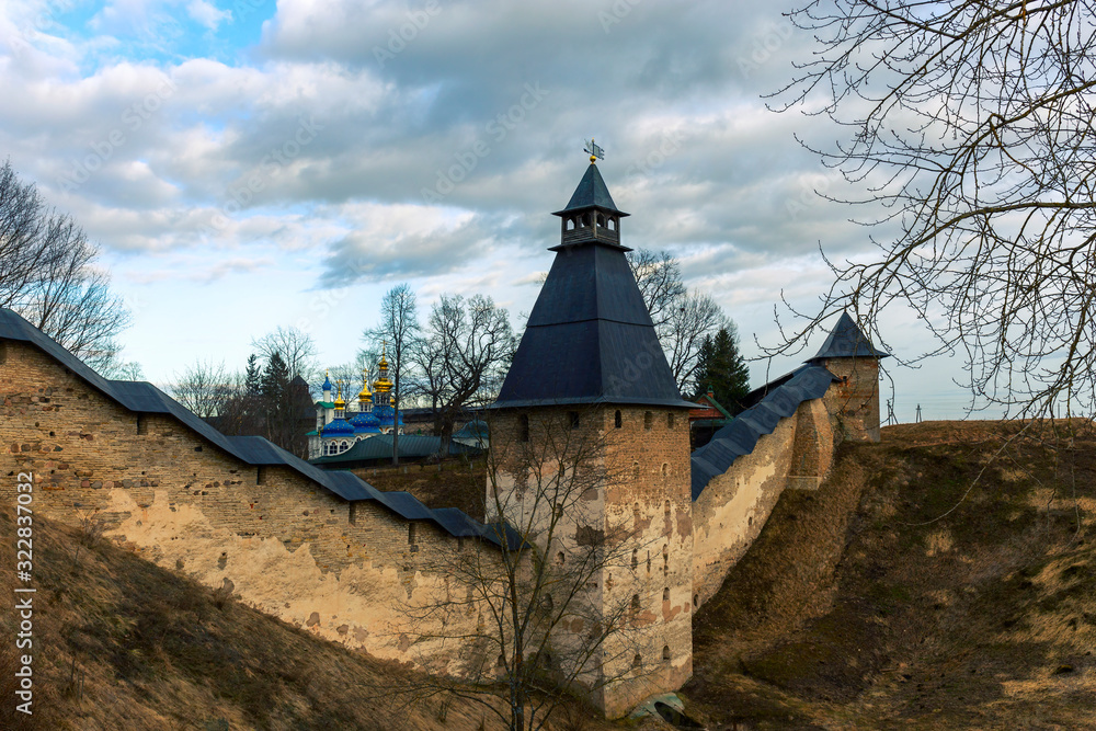 The Pskovo-Pechersk Monastery. There is a view of the towers and walls of the old fortress. Pskov region, Russia. The Pskovo-Pechersk Monastery. There is a view of the towers and walls of the old fortress. Pskov region, Russia.