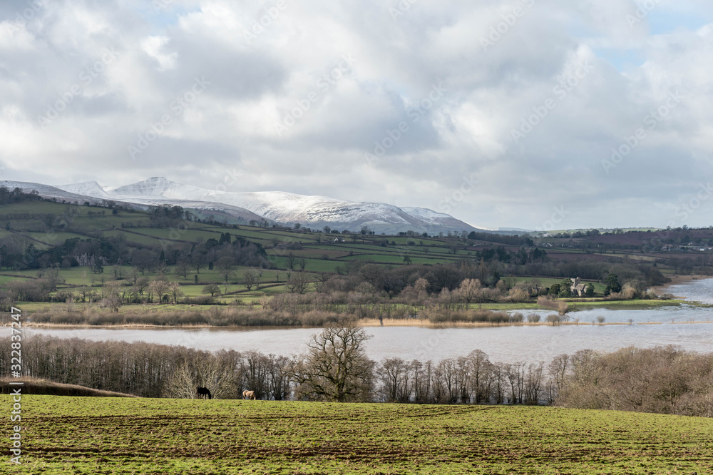 landscape with lake and mountains, llangorse lake and pen y fan with snow, brecon beacons national park