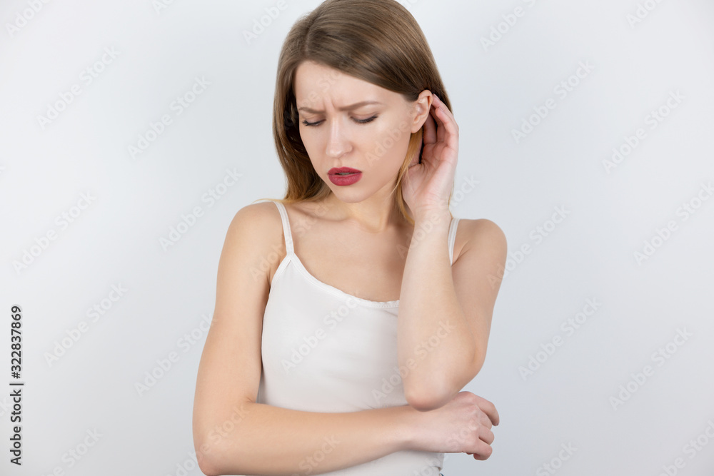young beatuiful blond woman looks upset standing alone on isolated white background, melancholic mood young beatuiful blond woman looks upset standing alone on isolated white background, melancholic mood
