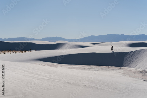 A man walking in the distance at White Sands National Park in Alamogordo, New Mexico. 