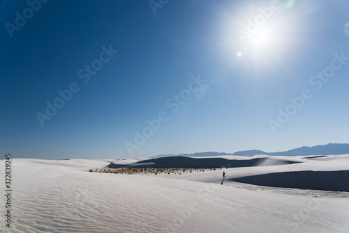 A man walking in the distance at White Sands National Park in Alamogordo  New Mexico. 