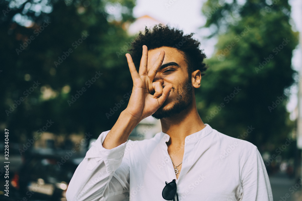 Young man gesturing while standing in city Young man gesturing while standing in city