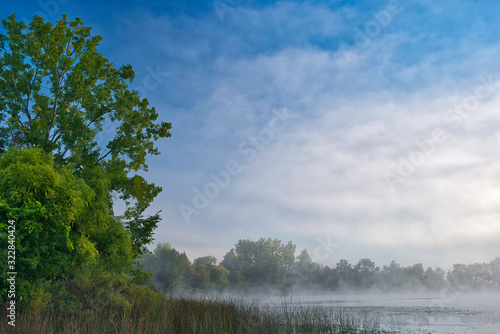 Foggy spring landscape of the shoreline of Whitford Lake at sunrise, Fort Custer State Park, Michigan, USA © Dean Pennala