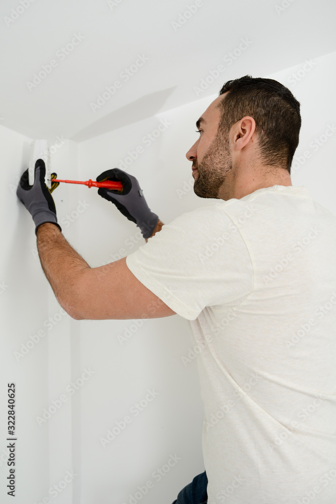 handsome man worker installing alarm technology insurance in home for burglar prevention handsome man worker installing alarm technology insurance in home for burglar prevention