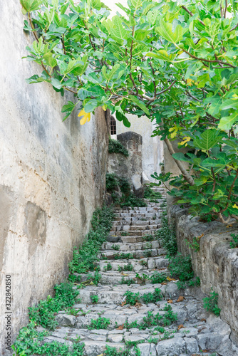 Fototapeta Naklejka Na Ścianę i Meble -  Small alley with stairs in Sassi of Matera, Italy.