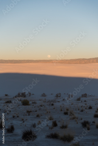 Full moon during sunset at White Sands National Park in Alamogordo, New Mexico. © Rosemary