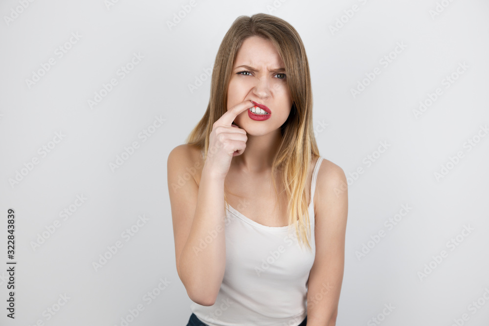 young beatuiful blond woman standing on isolated white background suffering from sudden gum pain, healthcare and medical concept young beatuiful blond woman standing on isolated white background suffering from sudden gum pain, healthcare and medical concept