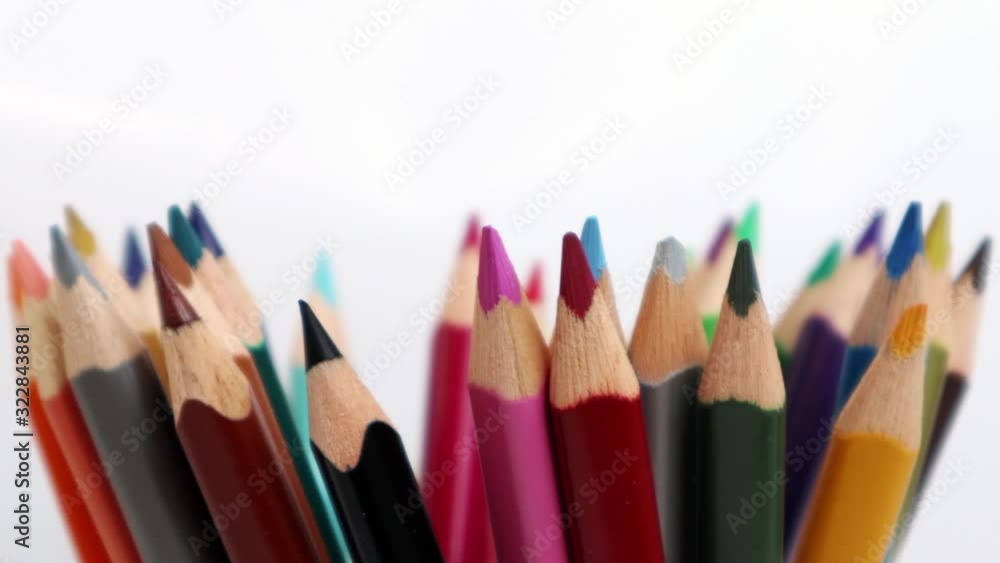 Top view on multi colored pencils rotating in white background. Close-up view on bright colored pencils for drawing in motion. 4K real time video. Copy space. Top view on multi colored pencils rotating in white background. Close-up view on bright colored pencils for drawing in motion. 4K real time video. Copy space.