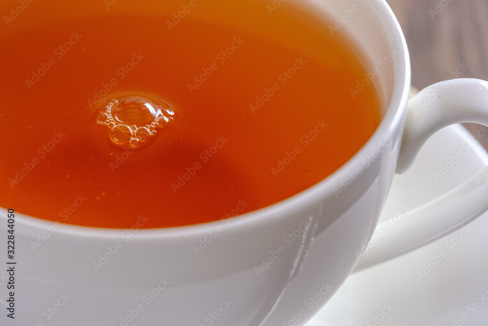 Fragrant and tasty tea in a cup close-up Fragrant and tasty tea in a cup close-up