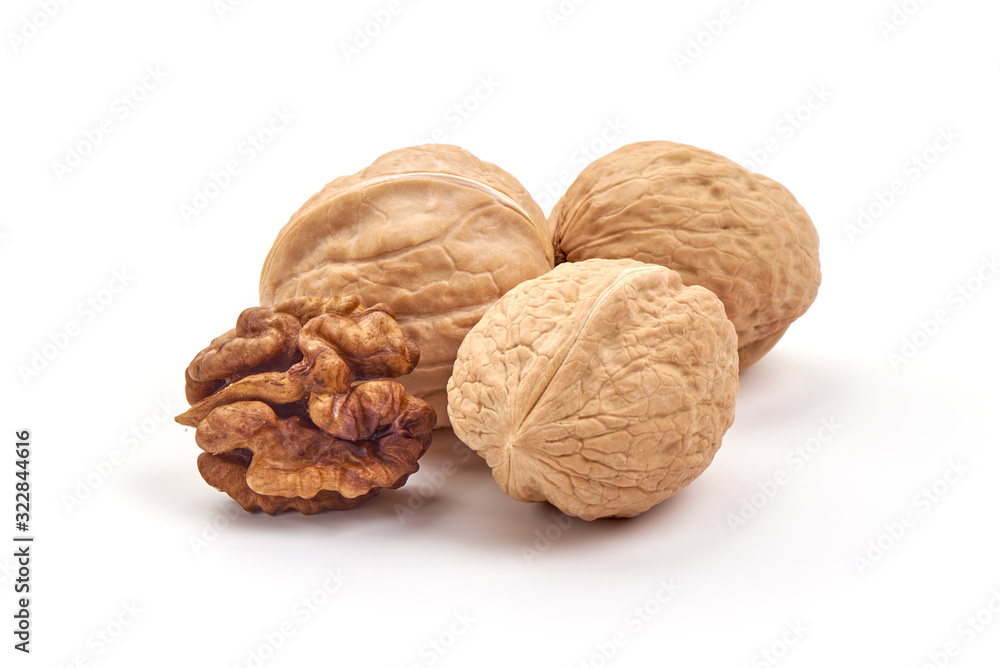Kernel and whole walnut, isolated on white background Kernel and whole walnut, isolated on white background