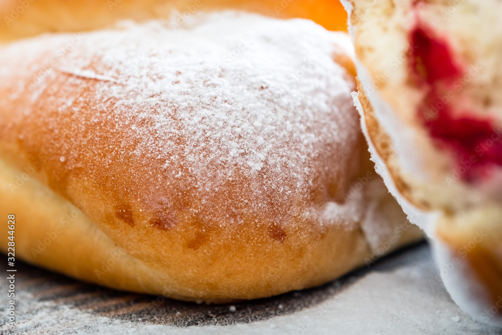 Fresh and rosy buns with cherry on a wooden table