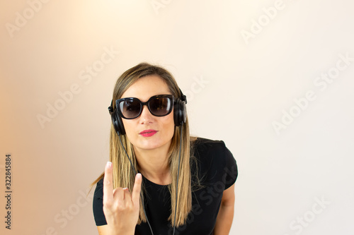 Young woman with glasses listening to music © Danko